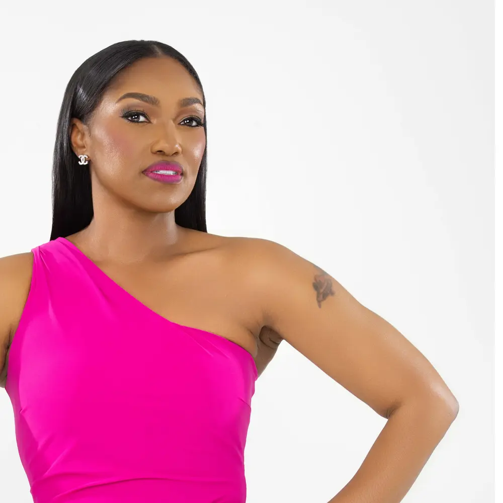 Dr. April Spencer in one arm pink jumper