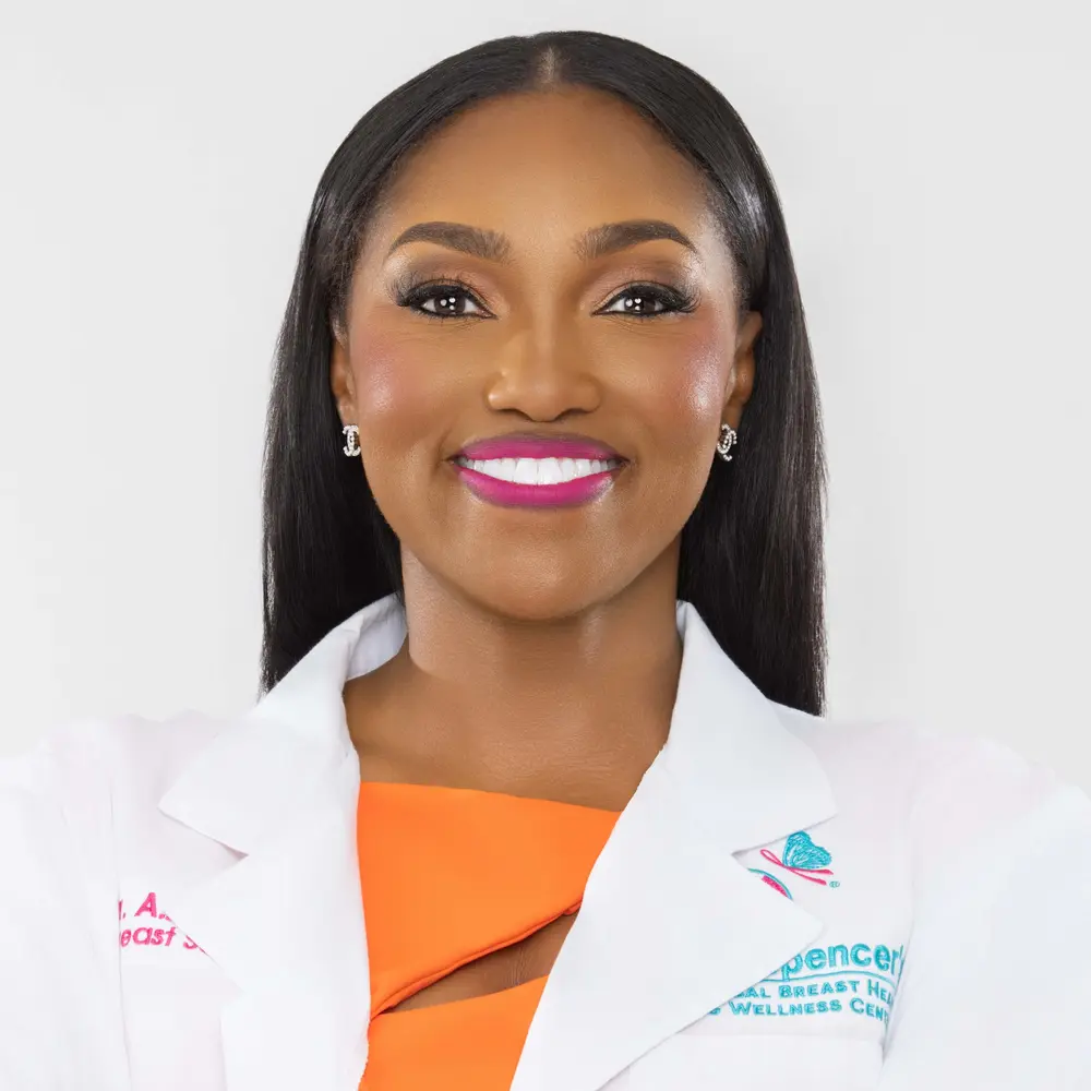 Dr. April Spencer in lab coat and orange dress