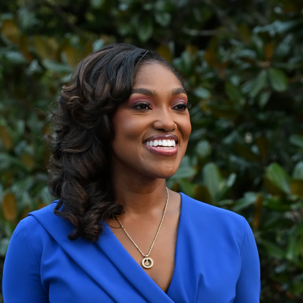 Dr. April Spencer gazing in a blue dress