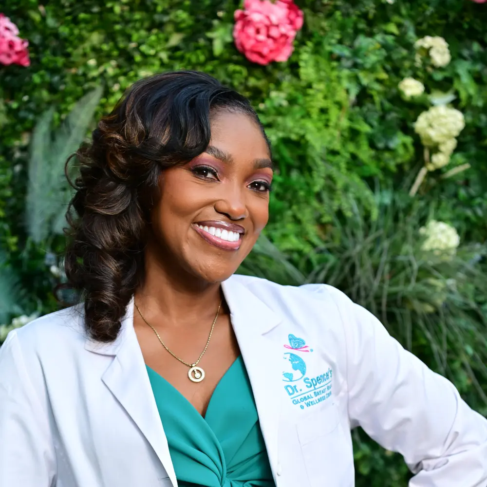 Photo of Dr. April Spencer in lab coat in garden